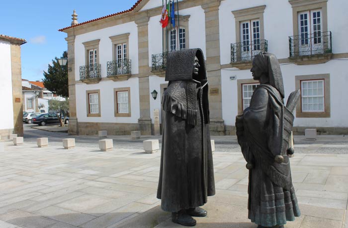Pareja de mirandeses con sus trajes típicos frente al Ayuntamiento qué ver en Miranda do Douro